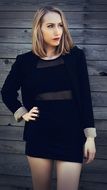 A young girl in a black suit