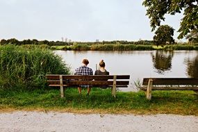 People on a bench by the lake