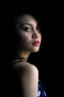 Portrait of the beautiful woman on the dark background