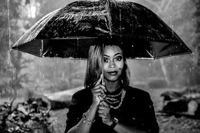 black and white portrait of a girl under an umbrella