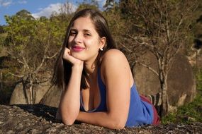 girl in a blue t-shirt on the background of nature