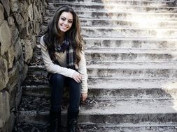 Sitting on Stairs unusually beautiful Girl