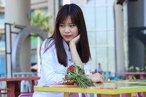 asian Girl is sitting on the chair outdoors