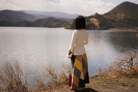 landscape of waiting and seeing woman on a coast