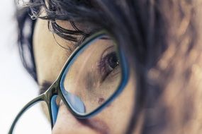 face of a brunette in glasses in profile