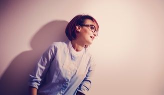 studio portrait of a woman in glasses