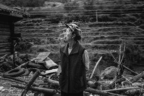 Photo of a man smoking a pipe in Southeast Asia