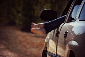 barefoot woman in the car