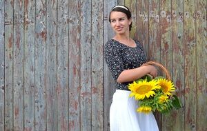 photo of a girl with a basket of sunflowers