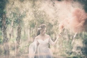 woman posing in the forest in the bridal dress