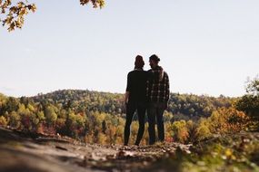 couple in love on top of the mountain in autumn