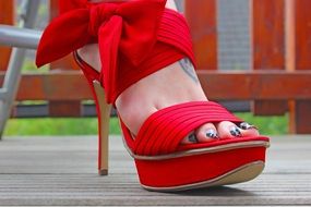 stylish red High heel Shoe on woman’s foot