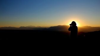 Photographer make photo of the sunset