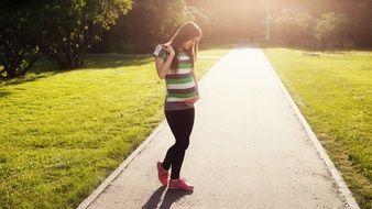 Walking Pregnant Girl in a park