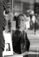 black and white photo of a girl in a beauty salon