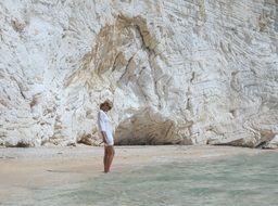 Beauty Woman on the coast with a white rock