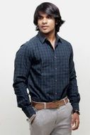 young man in a plaid shirt and trousers