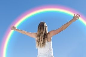 Young Woman Embracing rainbow, back view