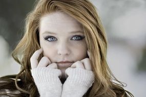 photo of a young girl with red hair in winter
