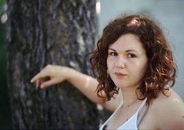 Portrait of the young girl near the tree