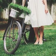 Girl in a white dress near the bike