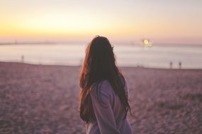 woman on a background of sunset on the beach