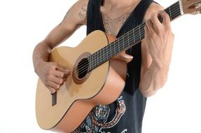 tattooed man playing guitar