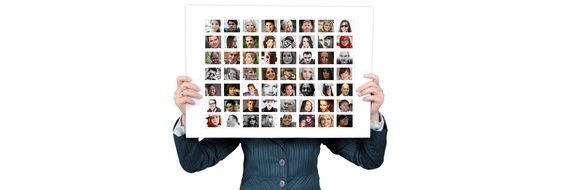 Woman holds set of portraits before face