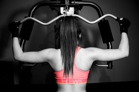 the girl is engaged on a sports simulator in the gym