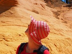 girl in a pink hat on a background of mountains in Roussillon