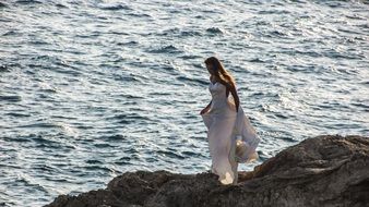 woman in romantic dress on the cliff