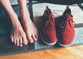 photo of male legs and red suede boots