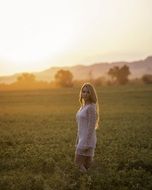 Girl under the sunset in summer