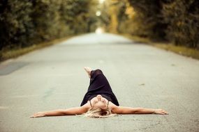 girl laying on the asphalt