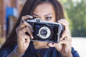 girl with a retro camera in her hands