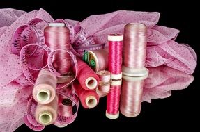 pink Sewing on a black background