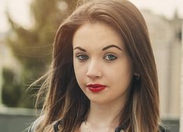 portrait of a girl with long hair on a blurred background