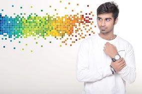 model guy in a white sweater on a white background with color patterns