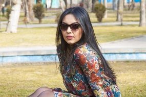 young woman with long hair posing in the park