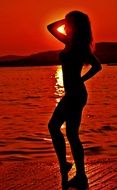 landscape of woman against sunset