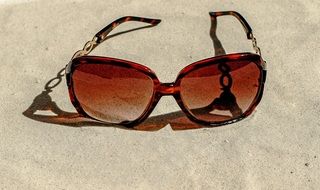 brown sunglasses on the beach close up