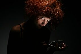 dark photo of a girl with curly red hair