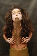 Fashion Concept, girl with chains in mouth