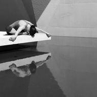 girl doing yoga on the shore of the pond