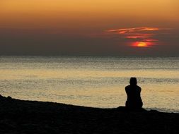 woman silhouette at beautiful Sunset Sea