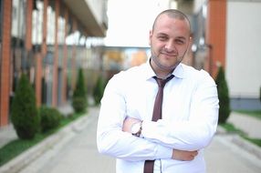 Businessman, young confident man in white shirt outdoor