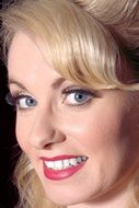 photo of smiling blonde with hairstyle and makeup