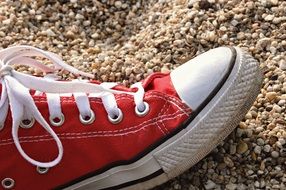 red shoe on the sand