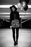 Girl with helium balloons