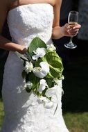 bride with bouquet and glass of champagne